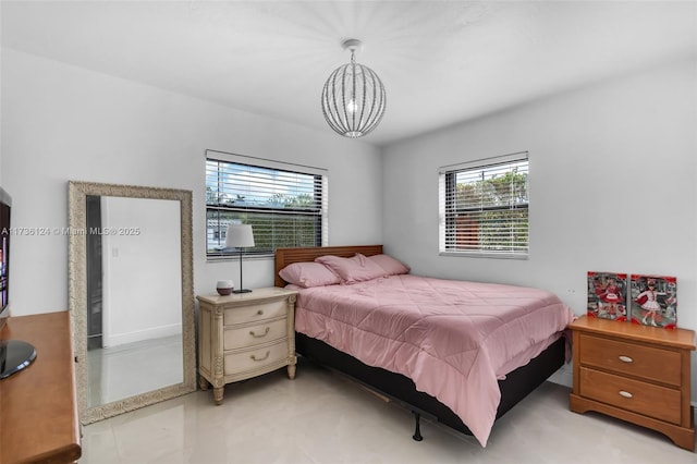 bedroom featuring multiple windows and a chandelier