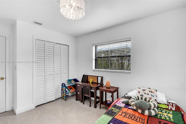 bedroom with a closet and a notable chandelier