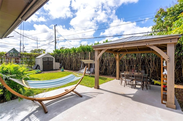 view of patio featuring a gazebo and a shed