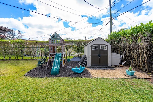 view of play area featuring a shed and a yard