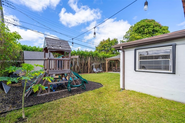 view of yard with a storage unit and a playground