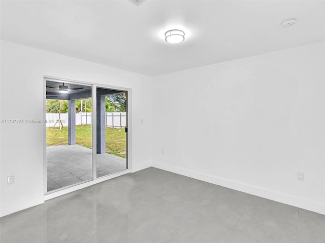 spare room featuring baseboards and ceiling fan