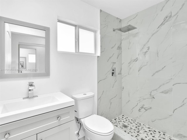 bathroom featuring vanity, a marble finish shower, and toilet