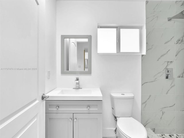 full bathroom with toilet, vanity, and a marble finish shower