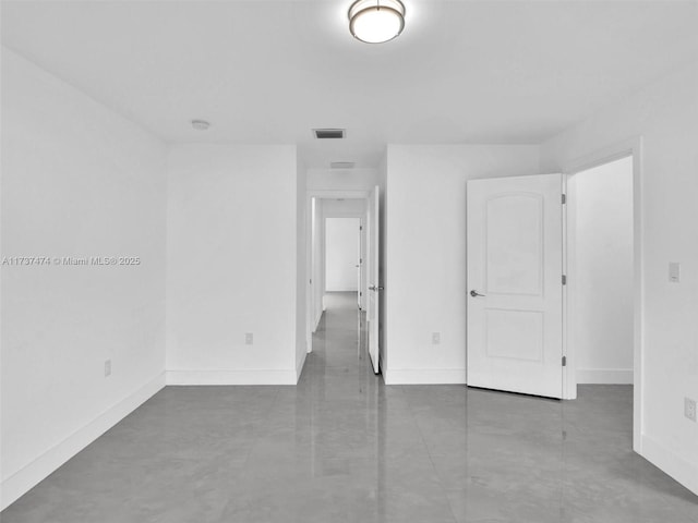 unfurnished bedroom with baseboards and visible vents