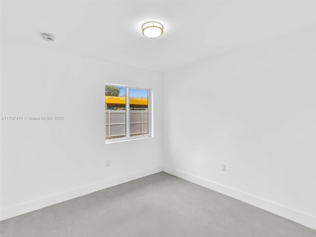unfurnished room featuring baseboards