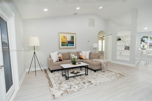 living room with vaulted ceiling and light hardwood / wood-style floors