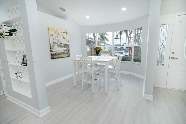 dining space with light hardwood / wood-style floors