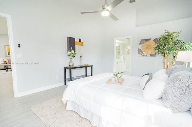 bedroom featuring ceiling fan, connected bathroom, and light wood-type flooring