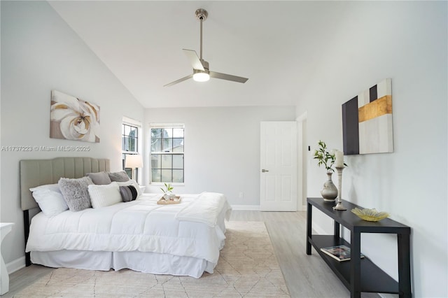 bedroom with lofted ceiling, light hardwood / wood-style flooring, and ceiling fan