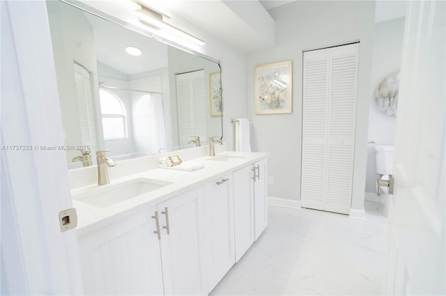 bathroom featuring vanity and toilet