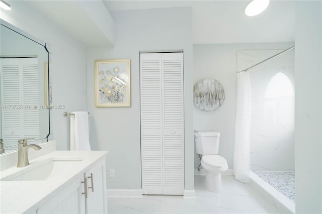 bathroom featuring vanity, curtained shower, and toilet