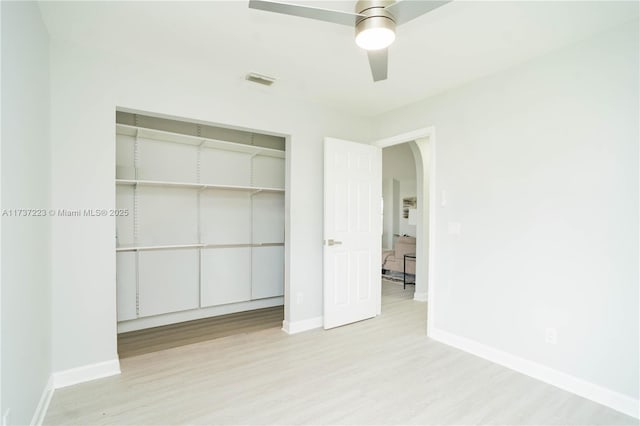 unfurnished bedroom featuring light hardwood / wood-style flooring, a closet, and ceiling fan