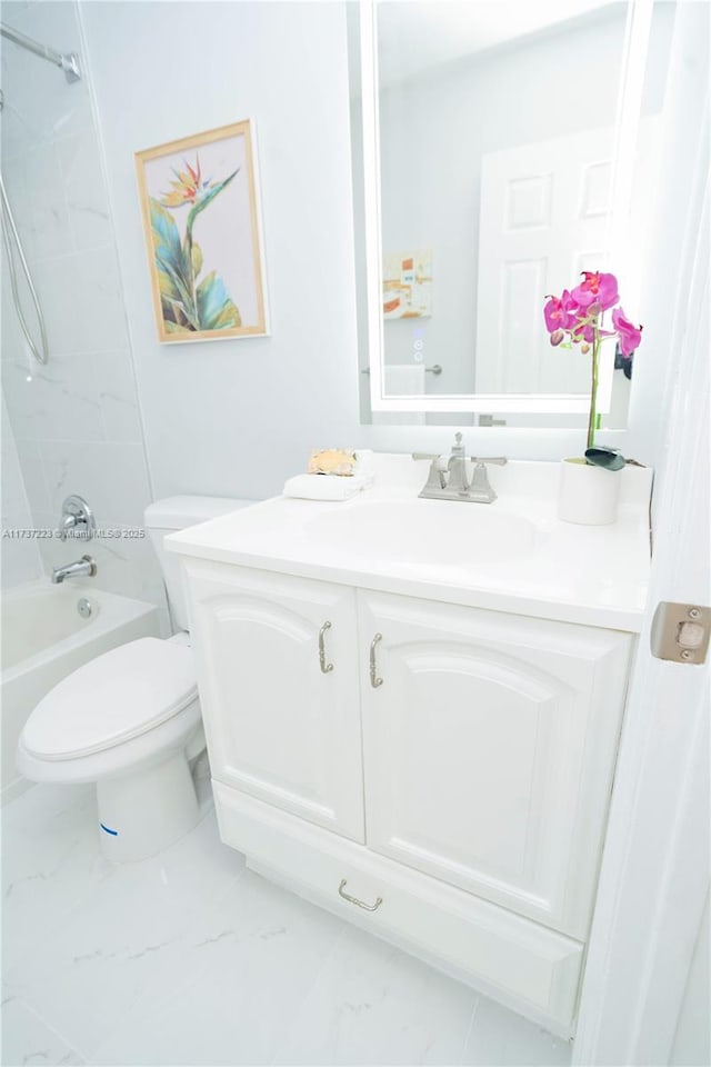 full bathroom featuring tiled shower / bath combo, vanity, and toilet