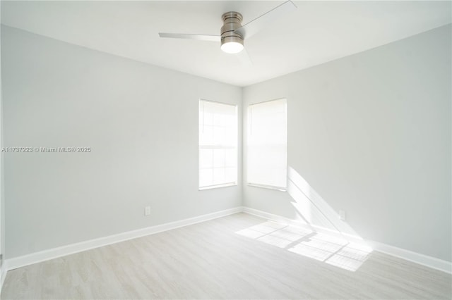 empty room with ceiling fan and light hardwood / wood-style flooring