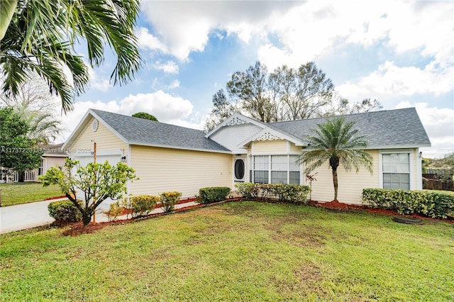 single story home with a garage and a front lawn