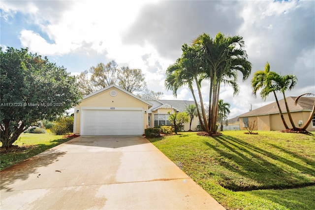 view of front of house with a garage and a front lawn