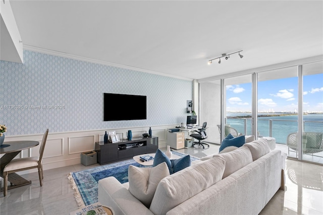 living room with ornamental molding and floor to ceiling windows