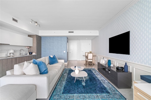 living room featuring ornamental molding and sink