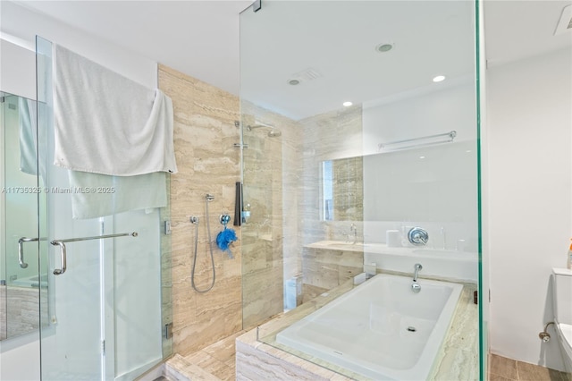 bathroom featuring shower with separate bathtub