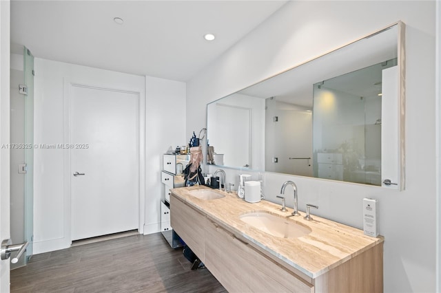 bathroom with vanity, an enclosed shower, and wood-type flooring