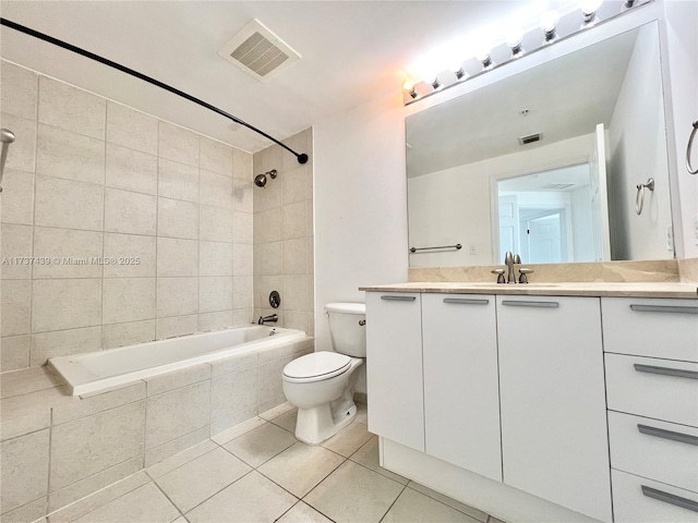 full bathroom with vanity, toilet, tile patterned floors, and tiled shower / bath