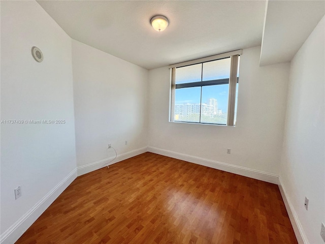 unfurnished room featuring hardwood / wood-style floors