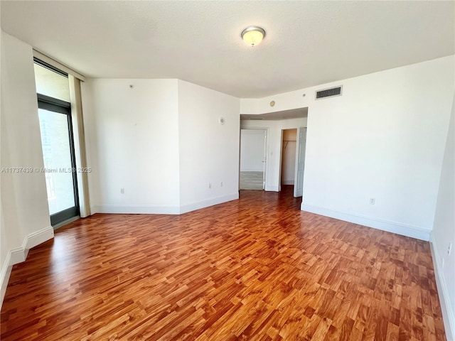 spare room featuring a textured ceiling and light wood-type flooring