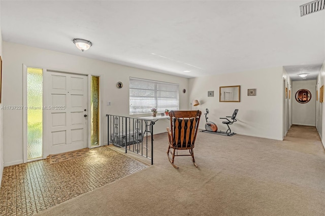 foyer featuring light colored carpet