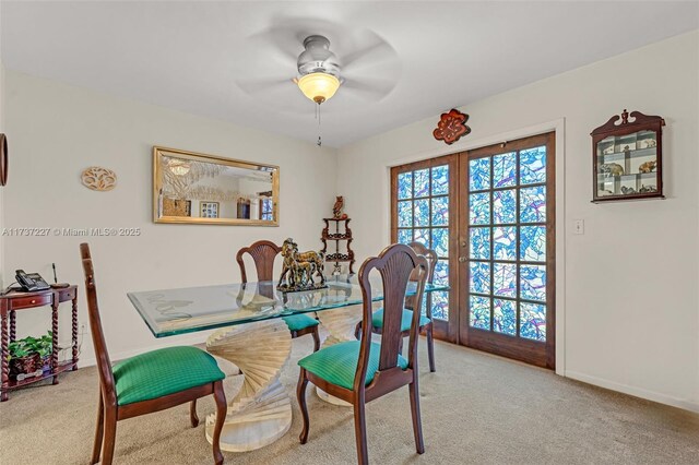 carpeted dining area featuring french doors