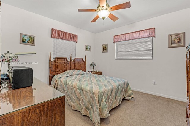 bedroom with light colored carpet and ceiling fan