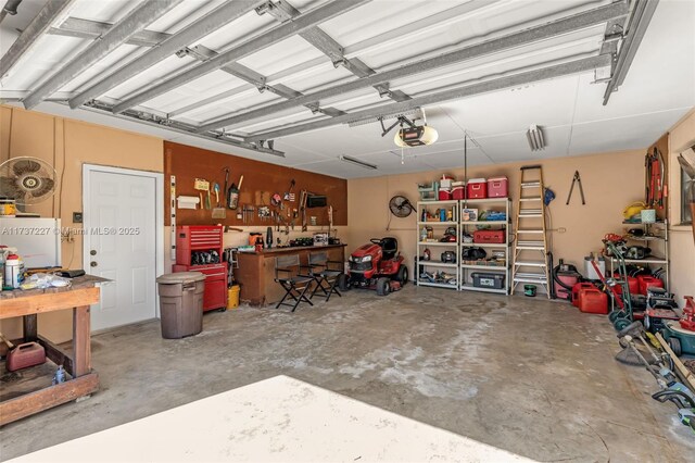 garage with a garage door opener and a workshop area