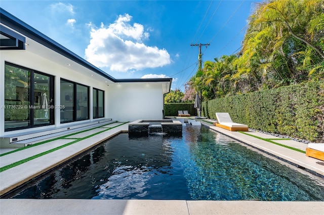 view of pool with an in ground hot tub and a patio