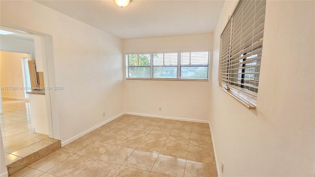 spare room featuring light tile patterned floors