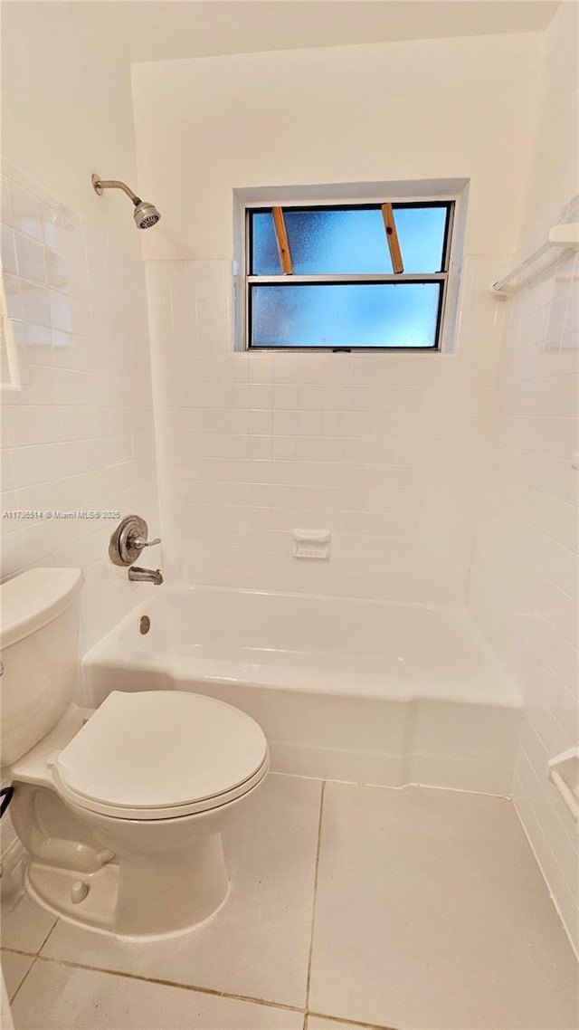 bathroom featuring tub / shower combination, tile patterned floors, and toilet