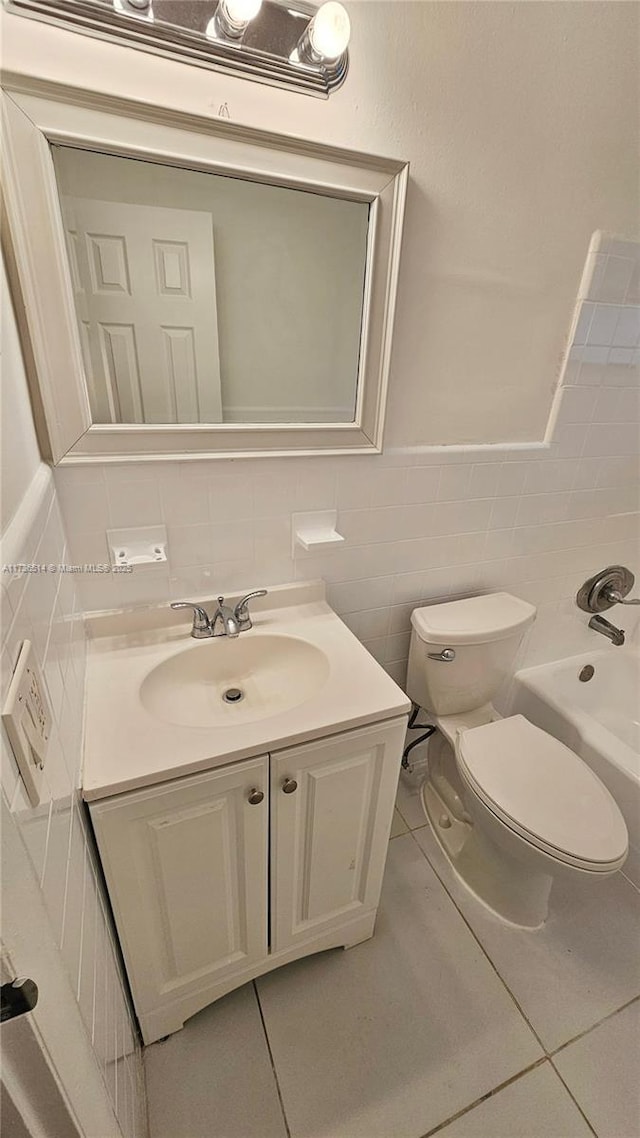 full bathroom featuring  shower combination, tile patterned flooring, tile walls, vanity, and toilet