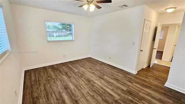 empty room with dark hardwood / wood-style floors and ceiling fan