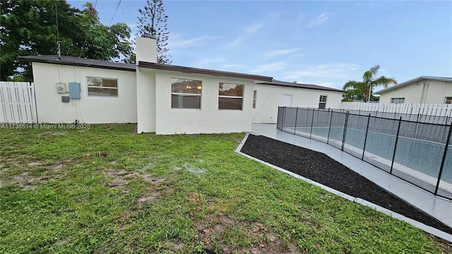 rear view of property with a yard