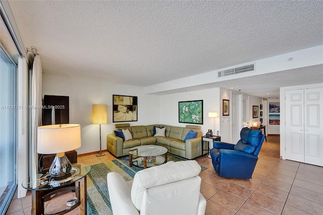 living room featuring tile patterned flooring and a textured ceiling