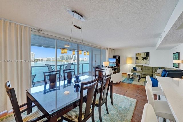 dining space featuring tile patterned floors, floor to ceiling windows, and a textured ceiling