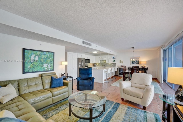 living room with light tile patterned floors and a textured ceiling