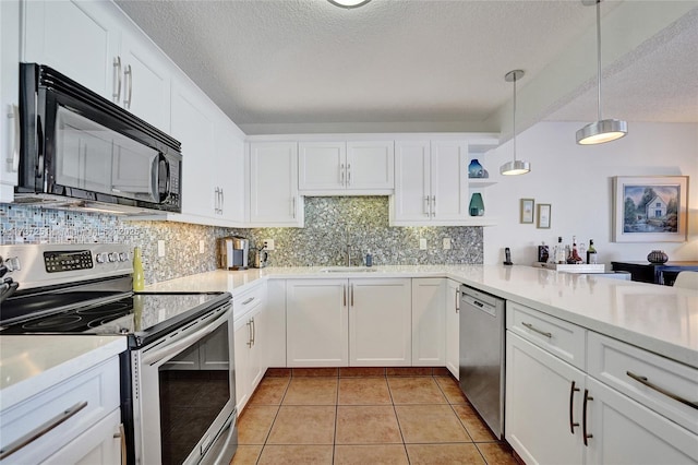 kitchen featuring stainless steel appliances, sink, white cabinets, and decorative light fixtures