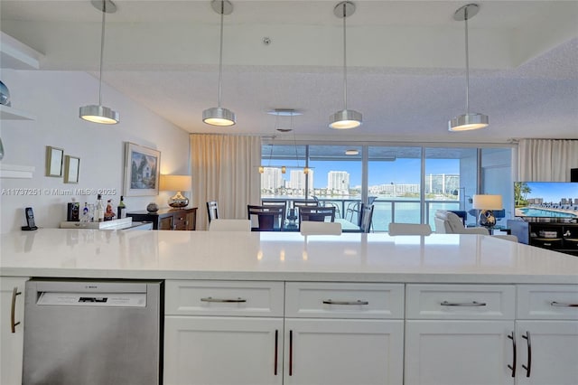 kitchen featuring a water view, dishwasher, hanging light fixtures, and white cabinets