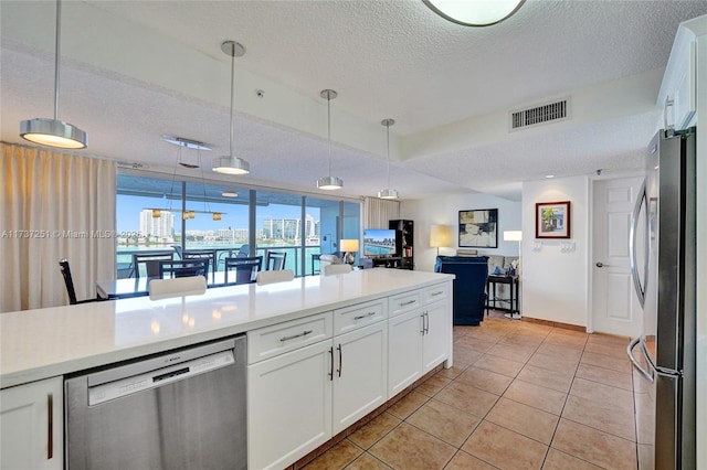 kitchen with white cabinetry, light tile patterned floors, decorative light fixtures, and appliances with stainless steel finishes