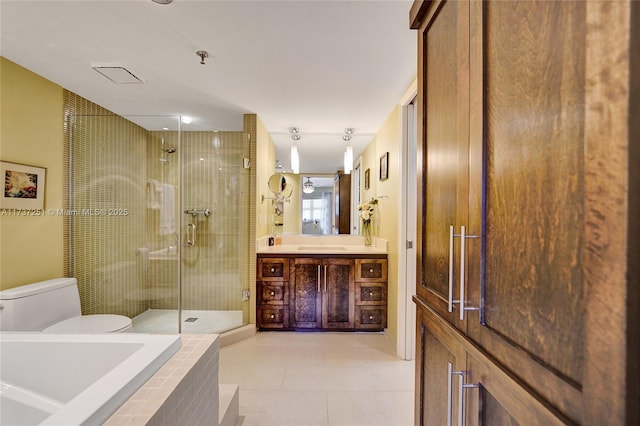 full bathroom with tile patterned flooring, shower with separate bathtub, vanity, and toilet