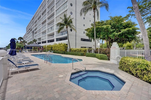 view of swimming pool with a gazebo, a community hot tub, and a patio