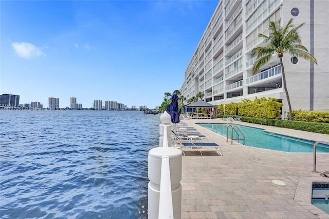 view of pool featuring a gazebo, a water view, and a patio