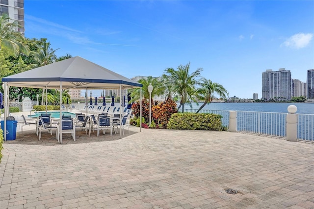 view of patio featuring a water view and a community pool