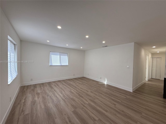 empty room with hardwood / wood-style flooring