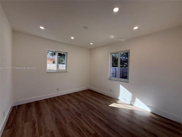 unfurnished room featuring dark wood-type flooring